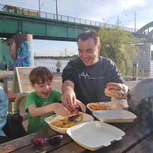 Peter Krzyzek and family sharing a riverside meal while working remotely