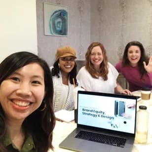 Ari Krzyzek and three founders smiling around a Brand Equity, Strategy & Design mastermind session